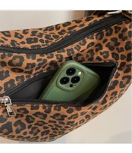 Detail of leopard print tote bag showing the front zipper pocket for mobile storage