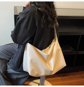 Close-up of a large beige hobo bag in soft matte PU leather showing a natural drape