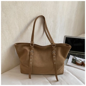 Brown faux suede tote bag displayed with laptop and magazine for professional office style