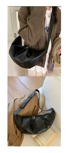 Detail of black wrinkled leather dumpling bag with double zippers and wide strap