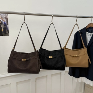 Three minimalist suede tote bags in coffee, black and khaki with metal buckles