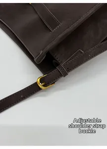 Detail of adjustable dark brown leather strap with vintage gold metal pin buckle closure