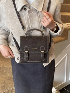 Retro coffee brown messenger bag in suede texture with dual buckle closure and top handle
