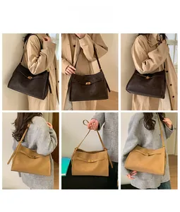 Detail view of leather tote bag showing the gold twist lock closure and adjustable strap