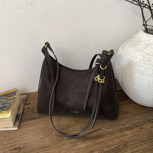 Detail of vintage dark brown faux leather shoulder bag texture with golden hardware