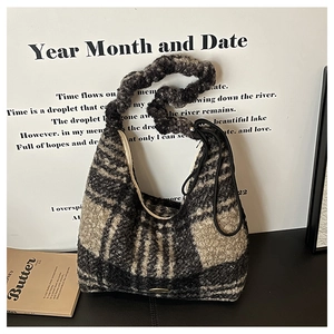 Detail of checkered plush tote bag with fuzzy texture and pleated handle for winter
