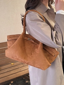 Brown suede minimalist tote bag with metal twist-lock and large capacity on a model