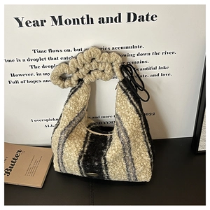 Detailed view of striped teddy fleece tote bag with a unique ruched scrunchie handle