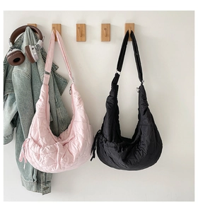 Detailed heart-shaped quilting and side drawstring on these half-moon shoulder bags