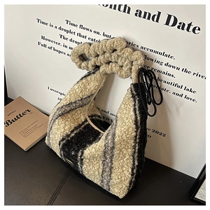 Close-up of color-block plush tote bag with ruched handle and fuzzy knit texture
