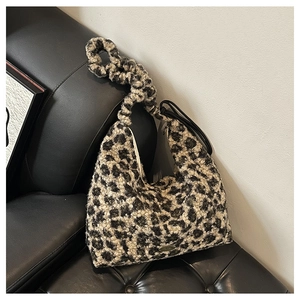Detail of leopard print plush tote bag with thick texture and dual strap design
