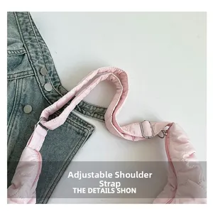 Detail of adjustable shoulder strap with silver buckle on pink heart-quilted bag