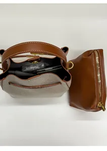 Detail view of canvas bucket bag with inner pouch showing storage for phone and cosmetics