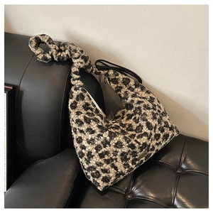 Detail of plush leopard print faux fur hobo bag with a pleated scrunchie shoulder strap