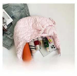 Detail view of pink quilted heart shoulder bag showing large capacity and internal storage