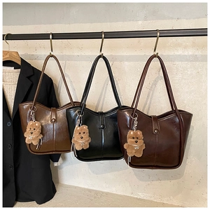Retro bucket bags in brown and black faux leather with cute plush bear charms detail