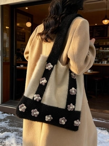 Winter knit tote bag with 3D floral accents in black and beige contrast style