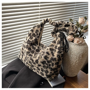 Detailed macro of leopard print faux fur tote bag with ruched handle and side drawstring