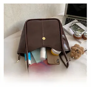Detail view of large brown faux leather tote bag interior showing ample storage space