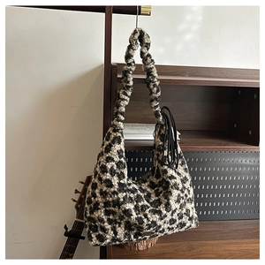 Detail of leopard print plush tote bag with a unique ruched shoulder strap and soft texture