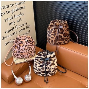 Three plush leopard print bucket bags with leather drawstrings and bow details
