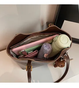 Spacious interior of dark brown leather tote bag showing large storage capacity