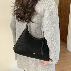 Detail of black suede Hobo bag with gold brand logo and adjustable strap hardware