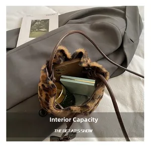 Internal storage view of leopard print bucket bag with phone and cosmetics inside