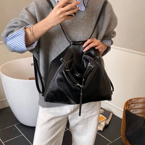 Detailansicht der schwarzen geometrischen Puzzle-Tasche mit weißen Kontrastnähten