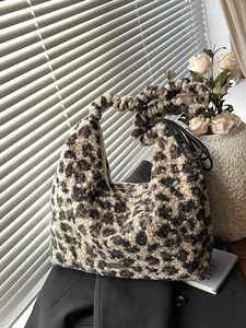 Winter leopard print plush tote bag with ruffled handle and stylish metallic logo plaque