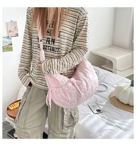 Pink quilted half-moon cloud bag with heart pattern stitching and adjustable strap