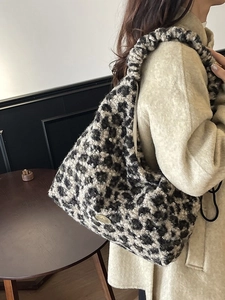 Winter faux shearling leopard print tote bag with ruched strap on beige wool coat