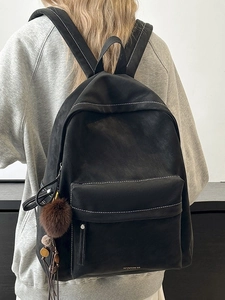 Vintage black large backpack with white stitching and plush ball charm for students