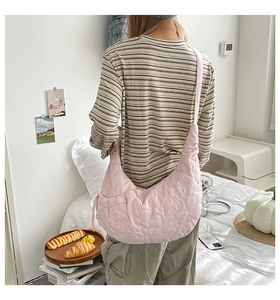 Detail of pink heart quilted pattern on soft crescent moon crossbody bag for women