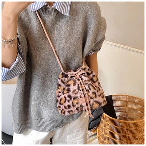 Detail of pink leopard faux fur bucket bag with a cute bow and drawstring strap