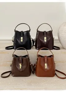 Detailed view of four vintage bucket bags in black, coffee, brown, and tan leather