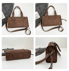Detail view showing brown retro boston bag texture with woven straps and silver studs