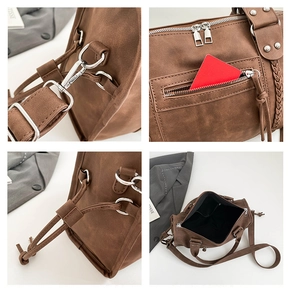 Detail shot of vintage brown tote bag showing stitching, silver hardware, and zippers