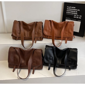 Close-up of four vintage leather shoulder bags in brown, caramel, coffee, and black