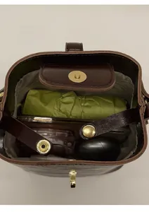Internal view of dark brown bucket bag showing capacity for phone, umbrella and cosmetics