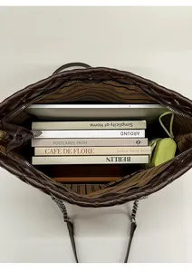 Macro detail of the spacious interior of a brown quilted tote bag showing large capacity