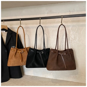 Detailed view of woven texture tote bags in camel, black and dark coffee leather finish