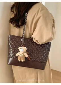 Quilted dark brown tote bag with metal chain strap and cute bear charm detail