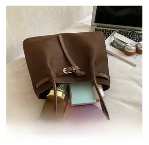 Detail of a brown woven tote bag showing large capacity for tablet and cosmetics