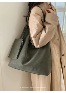 Detail of dark green suede tote bag with small zipper pouch in a minimalist retro style