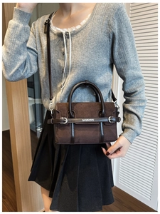 Détail du sac à main en daim marron foncé montrant la bandoulière et le style