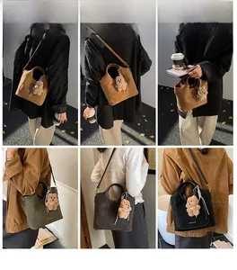 Detailed views of versatile large bucket bag with round handles and bear charm in lifestyle settings