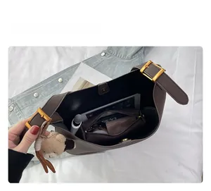 Intérieur du sac seau en cuir café avec espace pour tablette et charme d'ours