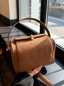 Retro brown crossbody bag with matte leather texture and metal lock for winter fashion