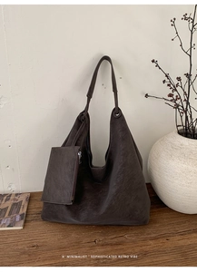 Detail of retro dark brown leather hobo bag with a detachable small zipper pouch